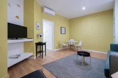 a living room with a couch and a table with chairs at APOSENTUS - Serenity Terrace in Porto