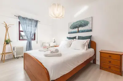 a bedroom with a bed with towels on it at Hopstays - Oporto Musica in Porto