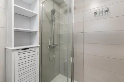 a shower with a glass door in a bathroom at Hopstays - Oporto Musica in Porto