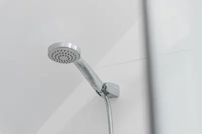 a shower with a shower head on a wall at GuestReady - Bonjardim Building in Porto