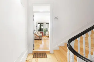 a hallway with a stairway with a white wall at República Garden View in Porto