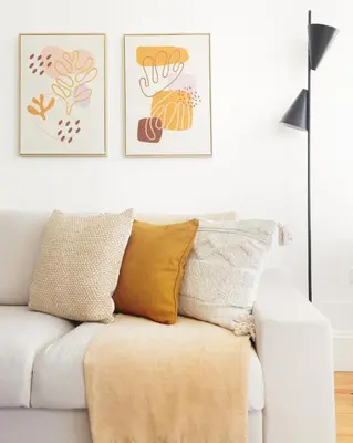 a living room with a white couch and two framed pictures at República Garden View in Porto