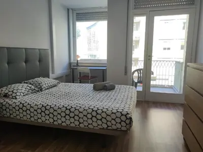a bedroom with a bed and a large window at DISCOVER PORTO - Boavista 2 in Porto