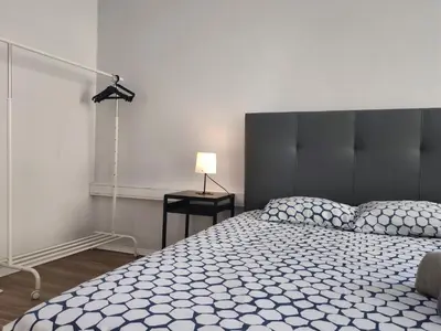 a bedroom with a bed and a lamp on a table at DISCOVER PORTO - Boavista 2 in Porto