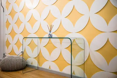a room with a yellow and white wall with a vase at Emotions Lapa Flat in Porto