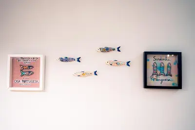 a wall with fish stickers on a white wall at Emotions Lapa Flat in Porto