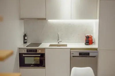 a kitchen with a sink and a stove at Downtown Amazing Duplex by Vacationy in Porto