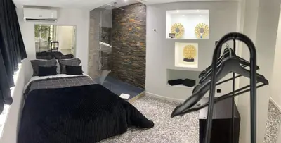 a bedroom with a bed and a walk in shower at Modern Room with Indoor Shower Near the River - Quarto Moderno com Duche interior Próximo da Ribeira in Vila Nova de Gaia