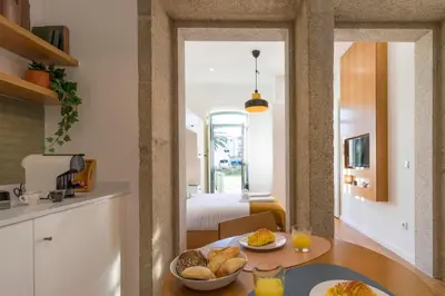 a kitchen and living room with a table with bread at WALAA Home@Almada Terrace by LovelyStay in Porto