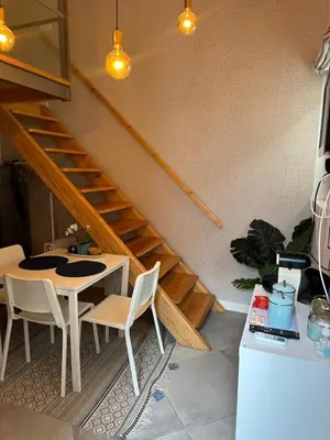 a dining room with a table and a staircase at Ilhas Douro Fontaínhas by PA Hotels in Porto