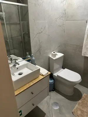 a bathroom with a toilet and a sink and a shower at Ilhas Douro Fontaínhas by PA Hotels in Porto