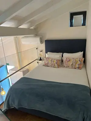 a bedroom with a large bed in a small room at Ilhas Douro Fontaínhas by PA Hotels in Porto