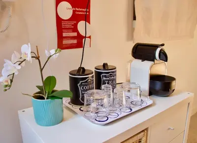a tray with glasses and a coffee maker on a counter at Ilhas Douro - Fontaínhas by PA Hotels in Porto