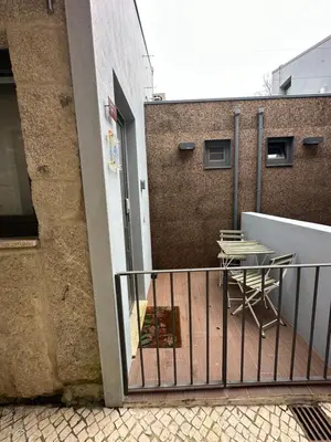 a balcony with a table and chairs on a building at Ilhas Douro - Fontaínhas by PA Hotels in Porto
