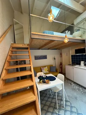a room with a dining table and a loft at Ilhas Douro - Fontaínhas by PA Hotels in Porto