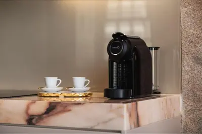 a coffee maker and two cups on a counter at Estefânia Luxury Apartment Historic House Downtown in Porto
