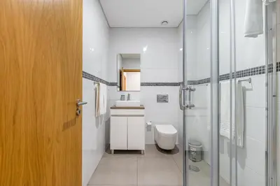 a bathroom with a toilet and a sink and a shower at Asgard Oporto Downtown Apartments in Porto
