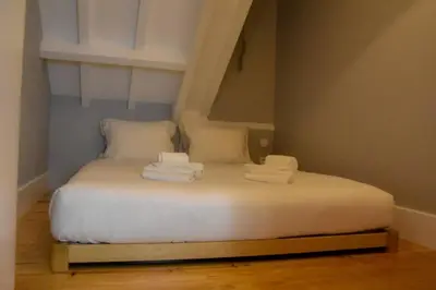 a bed with towels on it in a room at The Nest in Porto