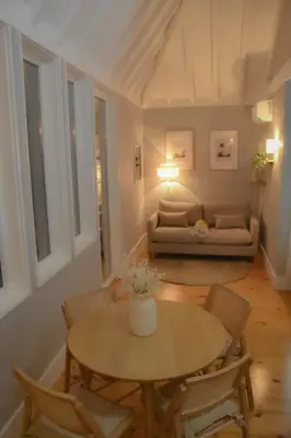 a living room with a table and chairs and a couch at The Nest in Porto