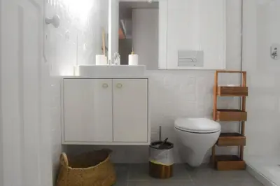 a bathroom with a toilet and a sink and a ladder at The Nest in Porto