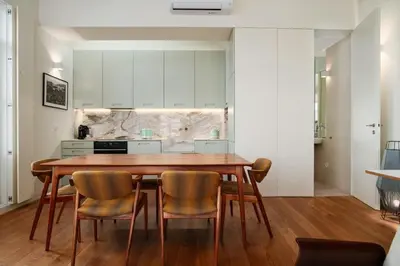a kitchen with a wooden table and chairs at Victoria Luxury Apartment, Historic House Downtown in Porto