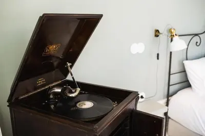 a record player in a wooden box in a bedroom at Victoria Luxury Apartment, Historic House Downtown in Porto