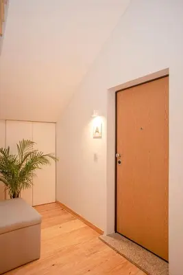 an empty room with a door and a plant at Liiiving in Porto-Mouzinho Residence Apartments in Porto