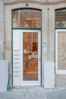 a door to a store with a car in the window at Liiiving in Porto-Mouzinho Residence Apartments in Porto