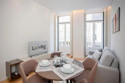 a living room with a table and a couch at Liiiving in Porto-Mouzinho Residence Apartments in Porto
