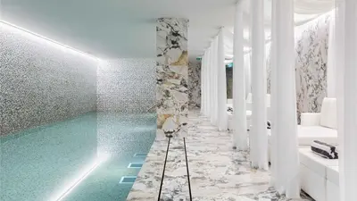 a bathroom with a turquoise swimming pool at Wine & Books Porto Hotel - Small Luxury Hotels Of The World in Porto