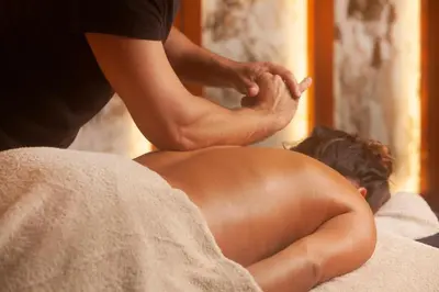 a man sitting on a bed getting a massage at Wine & Books Porto Hotel - Small Luxury Hotels Of The World in Porto