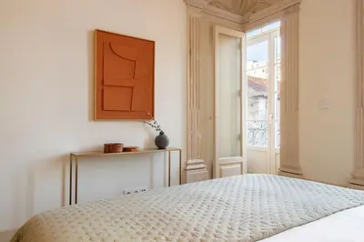 a white bedroom with a bed and a window at Casa Azul Santa Marinha in Vila Nova de Gaia