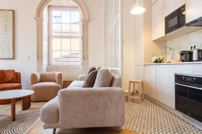 a living room with a couch and a chair at Casa Azul Santa Marinha in Vila Nova de Gaia