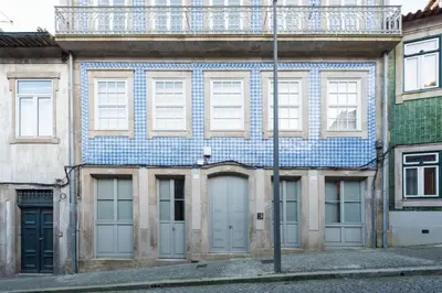 an old building with a blue and white tile roof at Casa Azul Santa Marinha in Vila Nova de Gaia