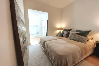 a bedroom with a large bed and a window at Dream On - Aliados Delux 2 Bed in Porto