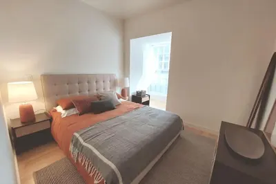 a bedroom with a large bed and a window at Dream On - Aliados Delux 2 Bed in Porto