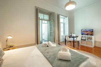 a living room with a bed with towels on it at Porto InLapa Apartment II Terrace in Porto