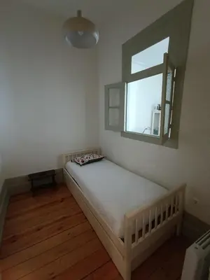 a small bedroom with a bed and a window at Porto InLapa Apartment II Terrace in Porto