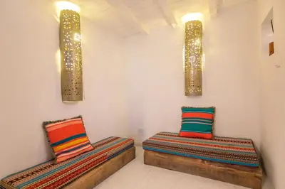 two beds with colorful pillows in a room at Porto InLapa Studio VI Garden in Porto