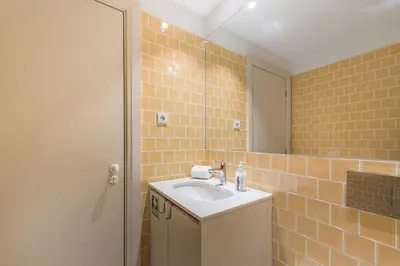 a bathroom with a sink and a mirror at GuestReady - Porto Wine District Penthouse in Vila Nova de Gaia