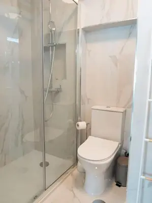 a bathroom with a toilet and a glass shower at APOSENTUS - Charming Torrinha in Porto