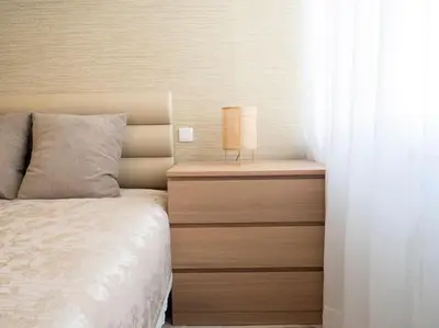 a bedroom with a bed and a nightstand with a lamp at APOSENTUS - Charming Torrinha in Porto