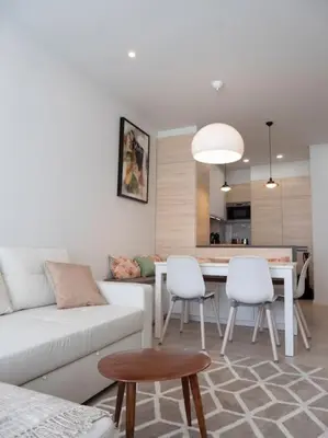 a living room with a couch and a table and chairs at APOSENTUS - Charming Torrinha in Porto