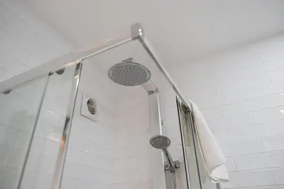 a shower with a glass door with a shower head at GuestReady - Grayscale in Porto
