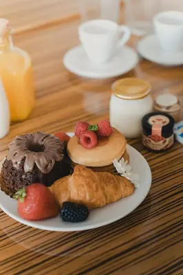 a plate of donuts and pastries on a table at ORM - São Lazaro Apartment in Porto
