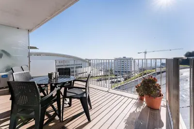 a table and chairs on a balcony with a view at GuestReady - Ideal stay near Estádio do Dragão in Porto