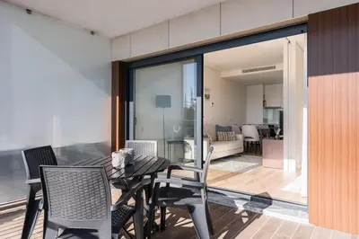 a dining room with a table and chairs on a balcony at GuestReady - Ideal stay near Estádio do Dragão in Porto