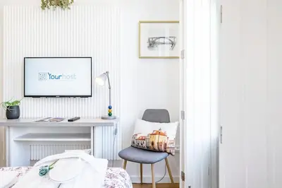a bedroom with a desk and a chair at Lovely Balcony Porto Downtown in Porto