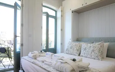 a bedroom with a bed with towels on it at Lovely Balcony Porto Downtown in Porto