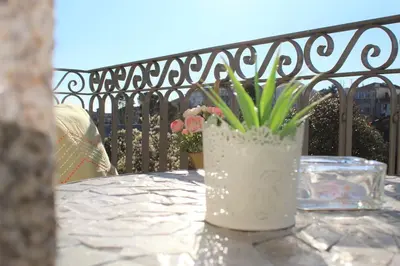 a white vase with flowers sitting on a table at Lovely Balcony Porto Downtown in Porto